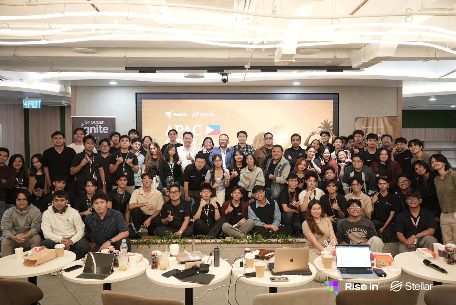 Every participant and organizer of the APAC Stellar Demo Day Philippines gathered in front of the event screen at the GCash office in Bonifacio Global City