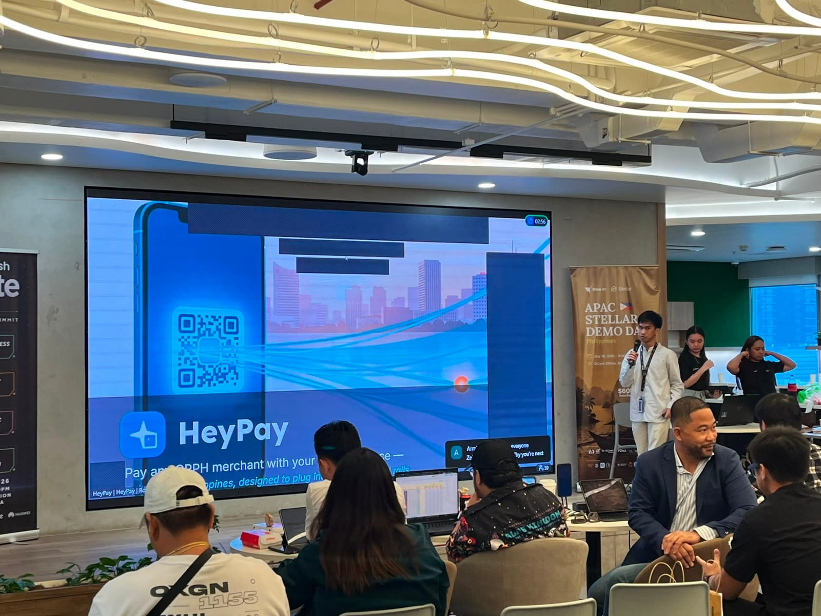 The HeyPay pitch on screen, showing a phone scanning a QRPH merchant code