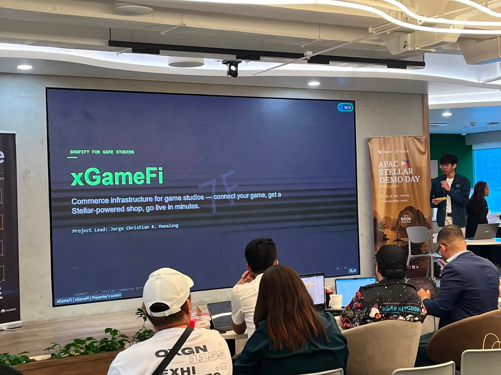 The xGameFi title slide — "Shopify for game studios" — on screen during its Demo Day pitch