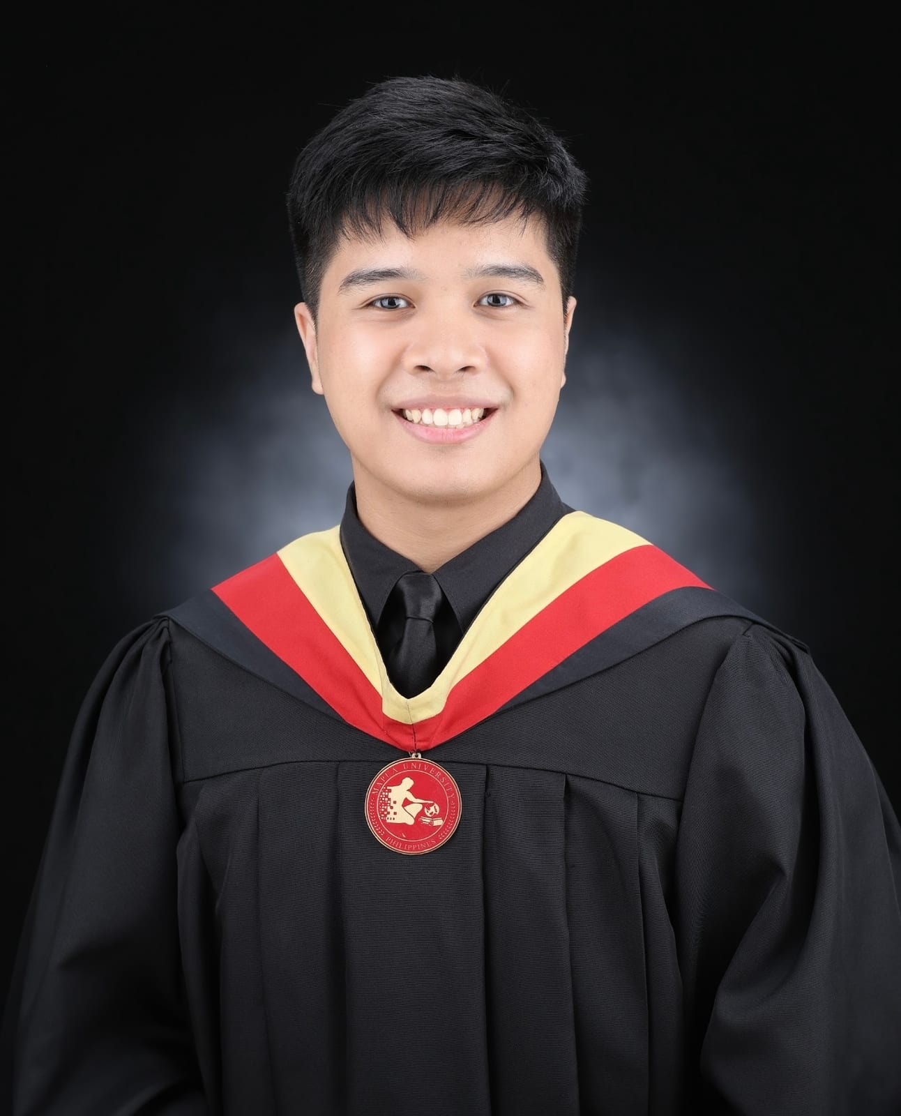 Carl Macabales in his Mapúa University graduation gown and medal