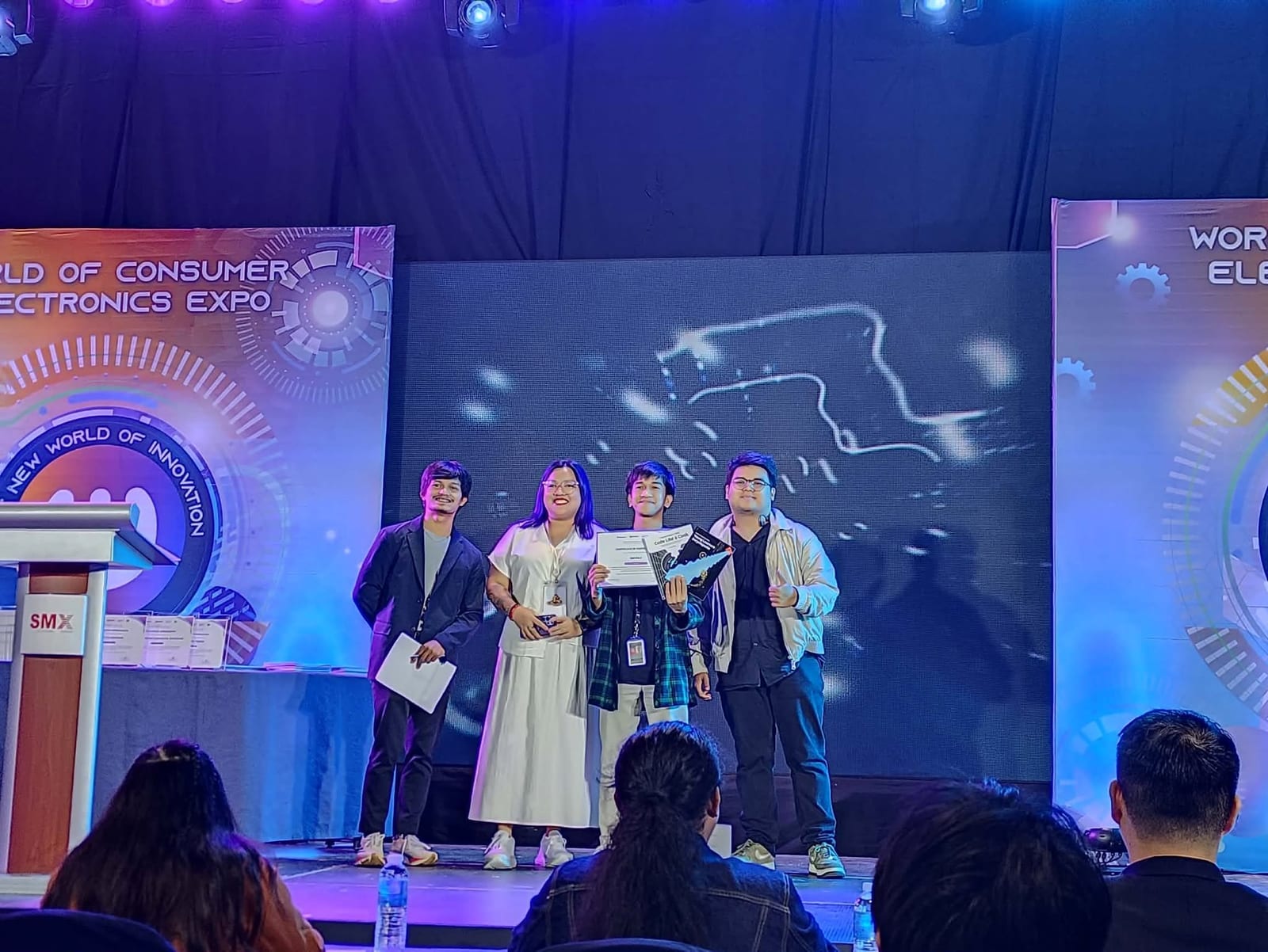 The HeyPay team on stage with their Cryptita Plays Builder Showcase certificate at WOCEE 2026